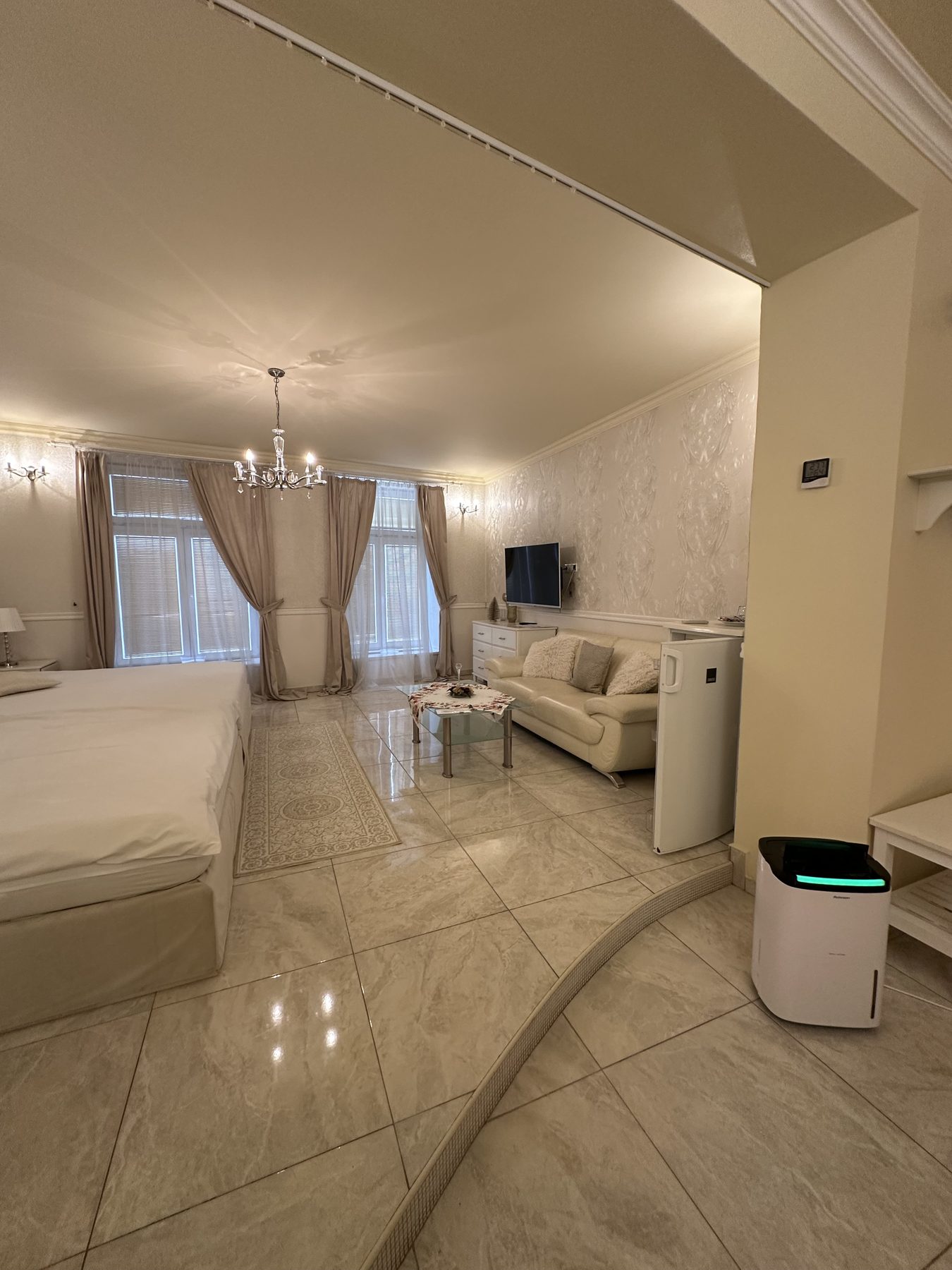 Prezidentské apartmá s wellness - obývací část s lůžkem, sedačkou a TV